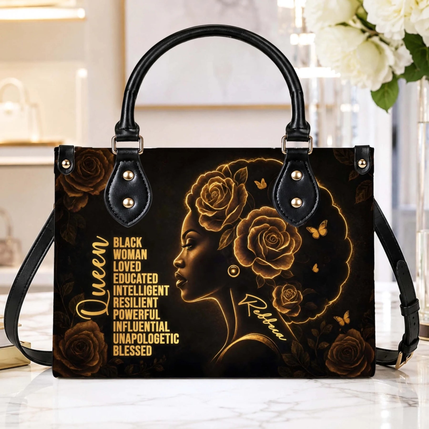 Elegant black queen tote bag with gold floral accents and a personalized name, perfect for a thoughtful custom gift.
