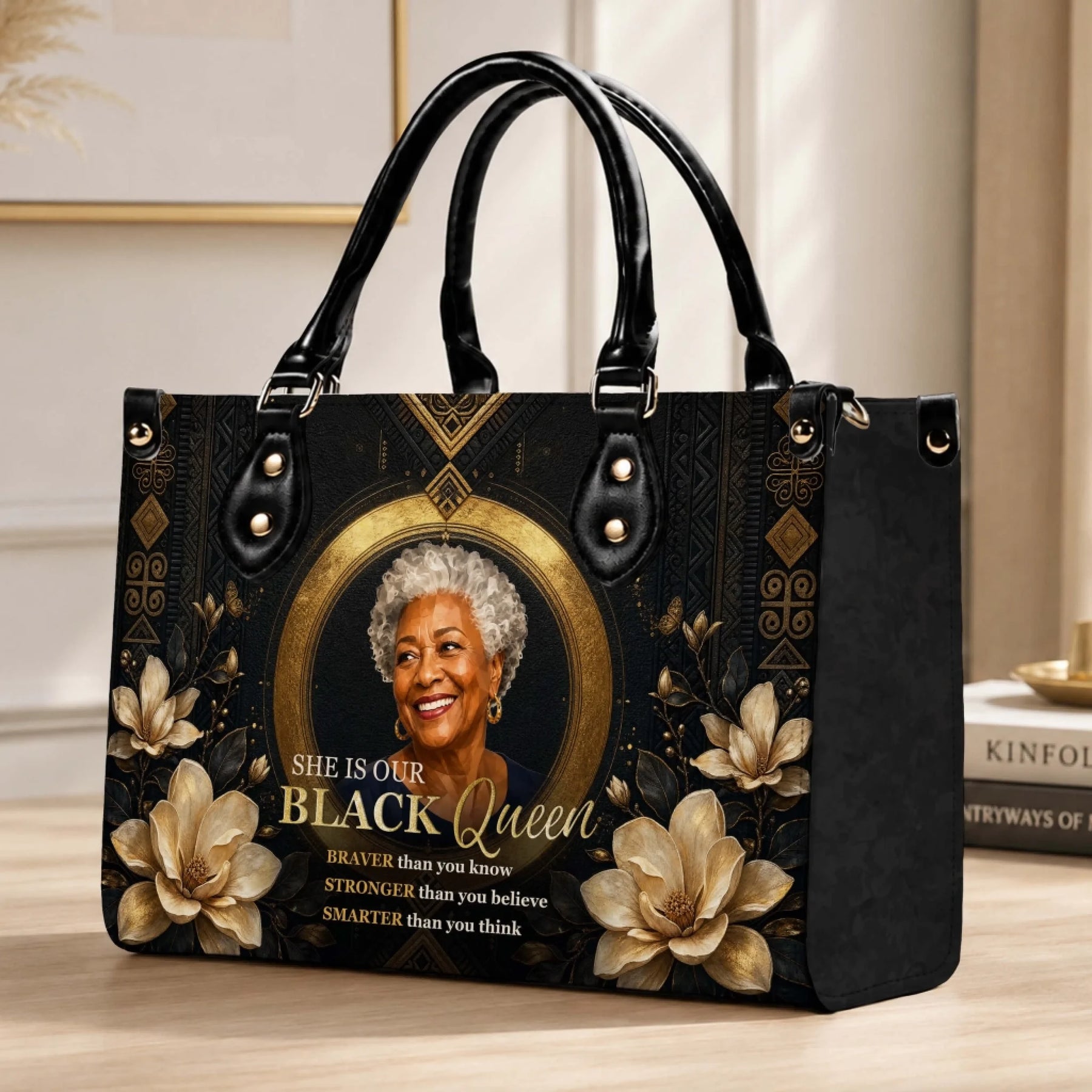 Decorative Black queen themed leather handbag with gold magnolia floral patterns and a classic structured design.