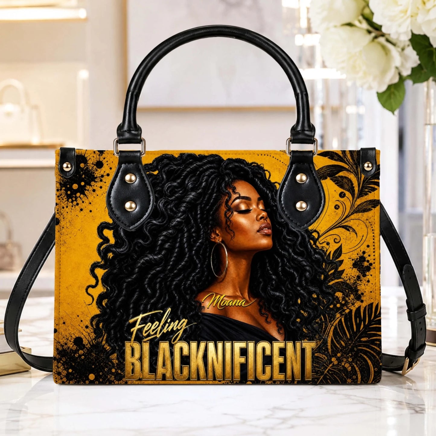 Stylish personalized handbag for women featuring gold artistic motifs and the empowering quote Feeling Blacknificent.