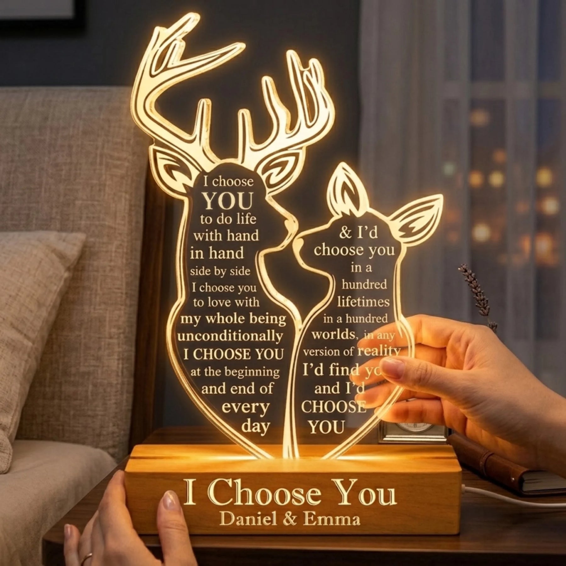 Hands holding a custom engraved acrylic deer night light with romantic wedding vow text and wooden base.