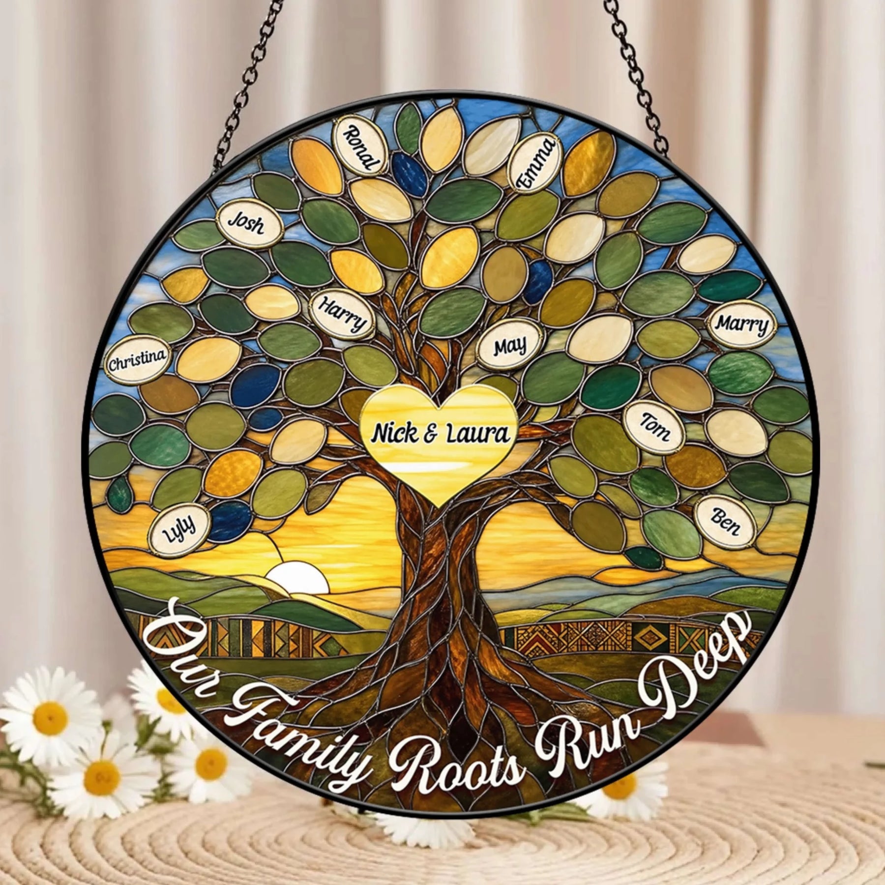 Personalized family tree stained glass suncatcher with custom names displayed on a table near white daisies.
