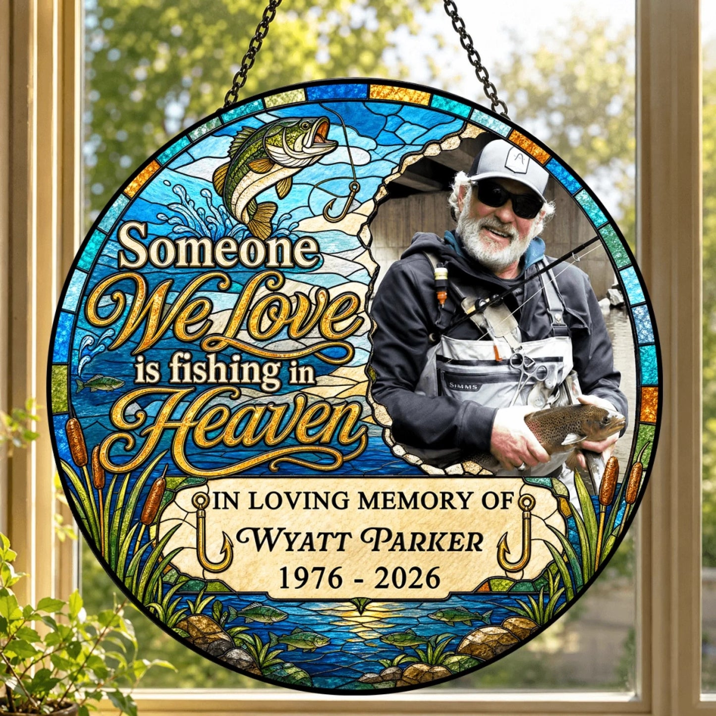 Round stained-glass memorial suncatcher featuring a fisherman, fishing art, and 'Someone We Love is Fishing in Heaven'.