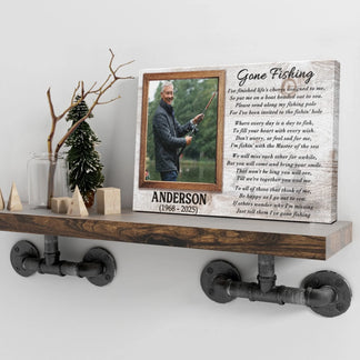 A distressed wooden plaque with a fishing photo and poem stands on a pipe-bracketed shelf, surrounded by decorative items.