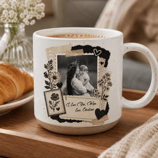 A white ceramic mug with a decorative scrapbooking-style design featuring a black and white photo and floral accents.