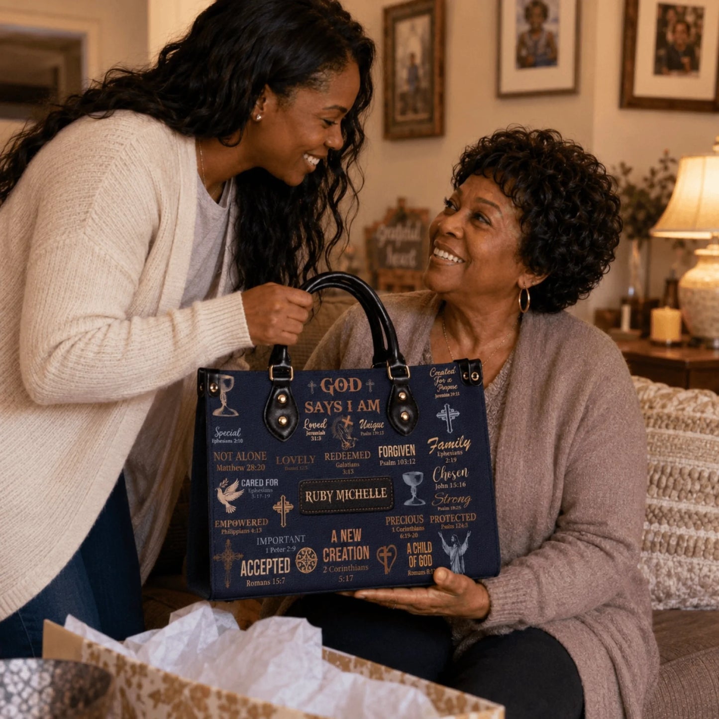 A woman gifting a personalized Ruby Michelle handbag with Bible verses to a smiling older woman for a special occasion.
