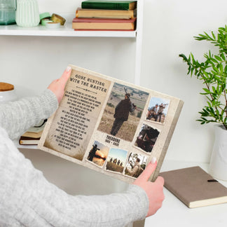 A person's hands gently hold a canvas print depicting a 'Gone Hunting with the Master' poem and a collage of hunting images.