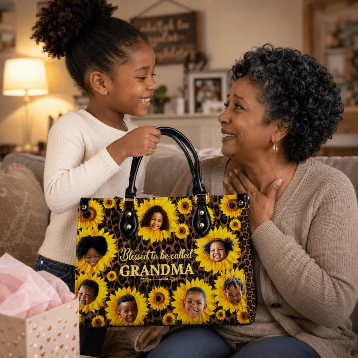 Young girl gifting a personalized sunflower tote bag with photo print to her grandma in a living room setting.