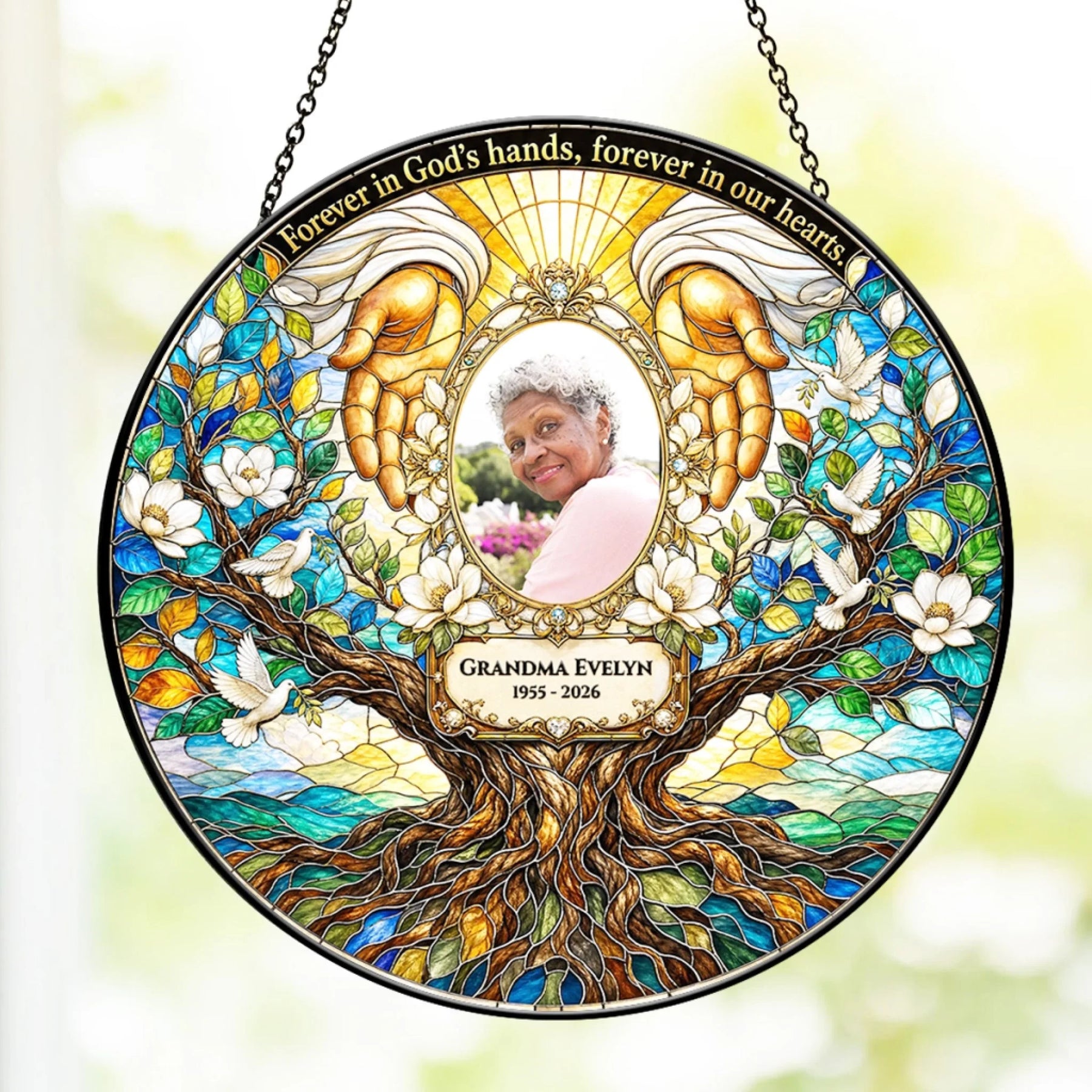 Personalized memorial stained glass suncatcher featuring Grandma Evelyn with angel hands and a tree of life design.