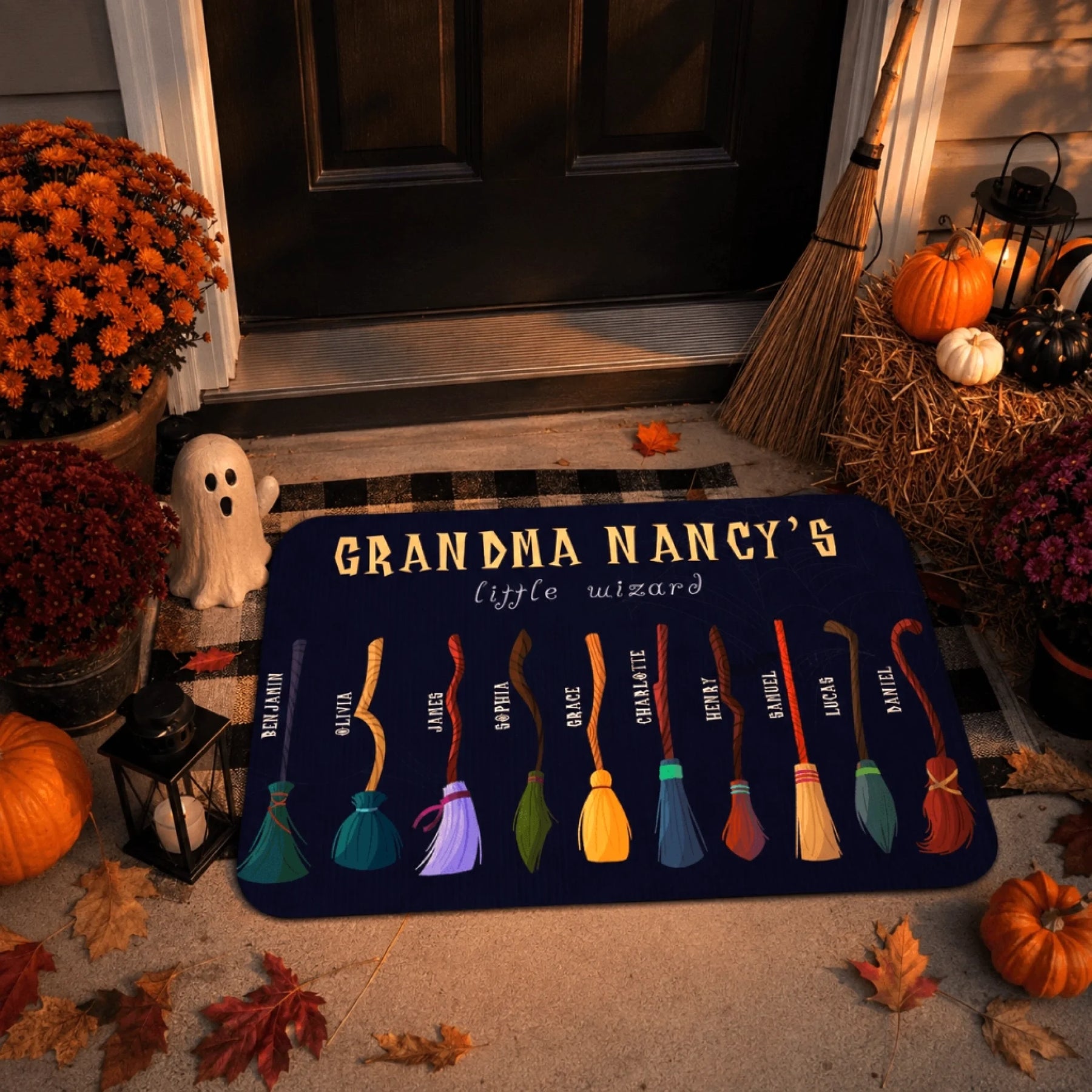 Halloween themed personalized doormat featuring Grandma Nancys little wizard text and broomsticks on a porch with pumpkins and ghost decor.
