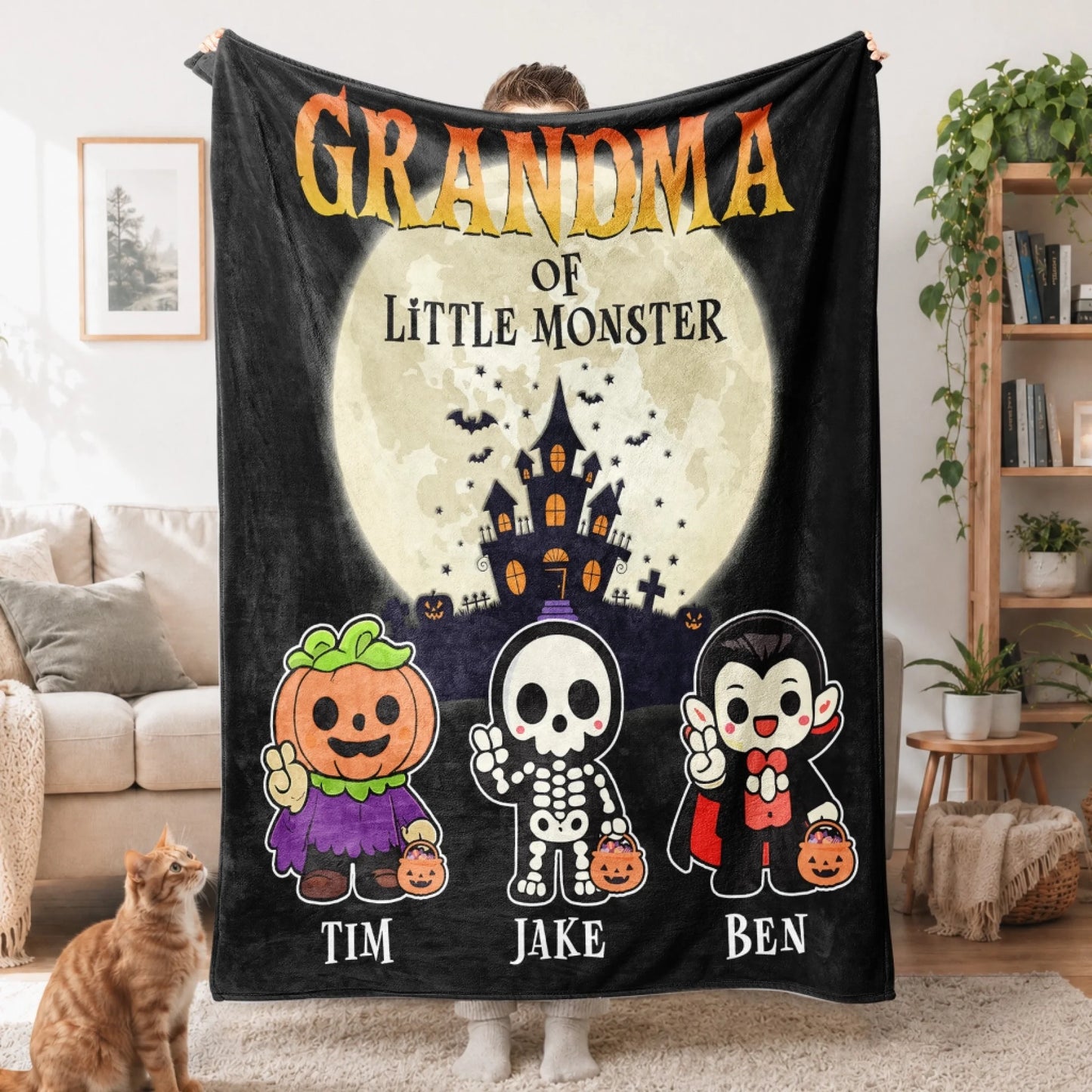 Personalized Halloween blanket for grandma with a haunted house graphic and names of three little monsters.