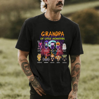 A man wears a personalized black Halloween graphic t-shirt featuring a Grandpa of Little Monsters custom design.