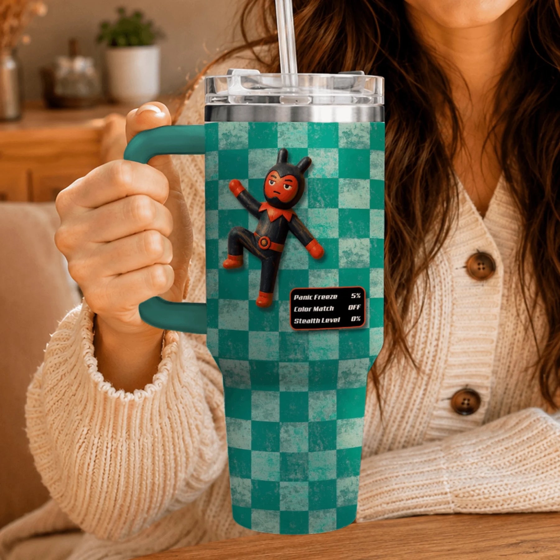 Hand holding a personalized 40oz tumbler with a funny devil character and gaming stats overlay