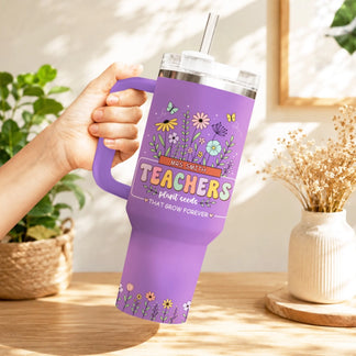 Woman holding a purple floral teacher appreciation tumbler with a handle, featuring a botanical design.