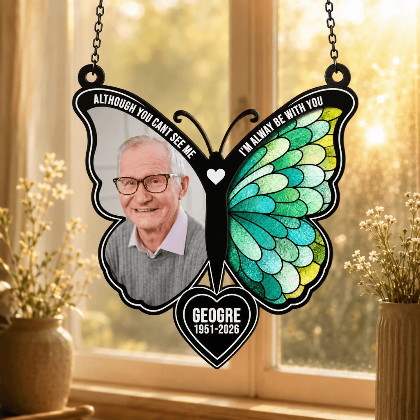 Stained glass style butterfly suncatcher personalized with a man's photo and memorial details, hanging by a window.