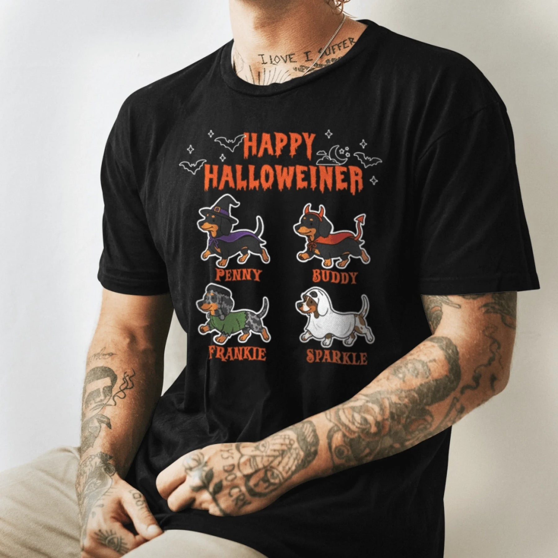 Black t-shirt for Halloween featuring cute illustrations of four dachshund dogs with their names for pet enthusiasts.