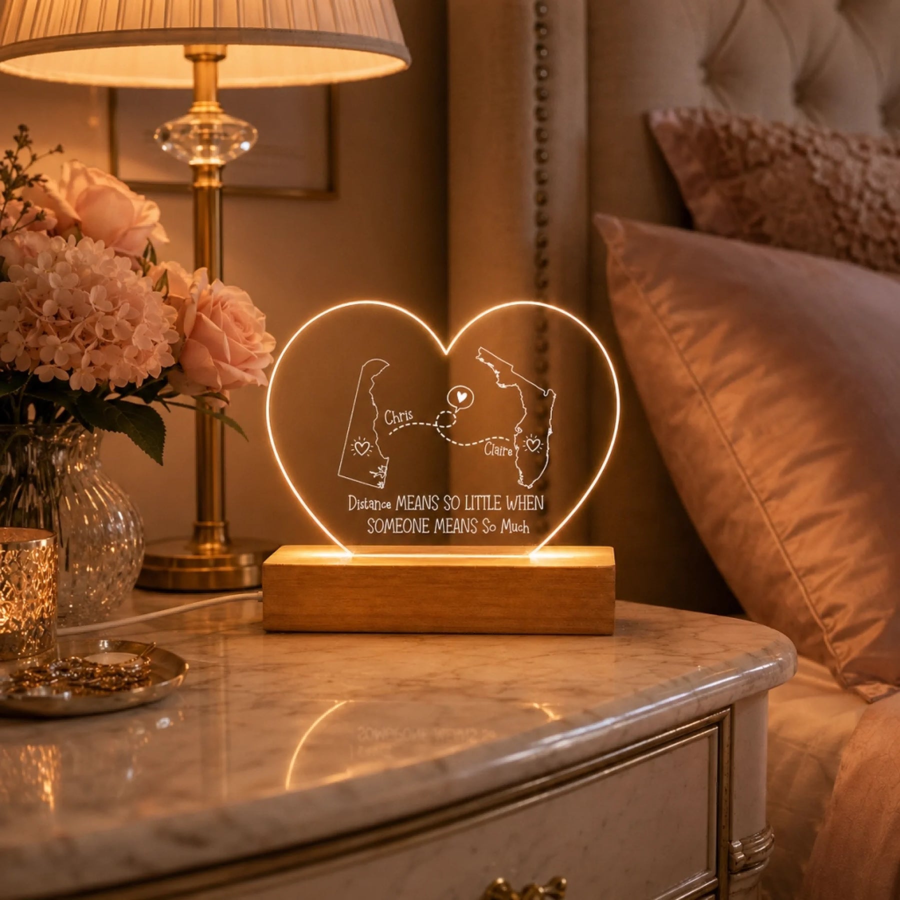 heart shaped custom map acrylic lamp next to a picture frame
