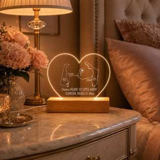 heart shaped custom map acrylic lamp next to a picture frame