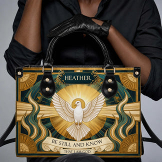 Personalized religious handbag featuring a white dove and the text Be Still and Know That I Am God, perfect for Christians.