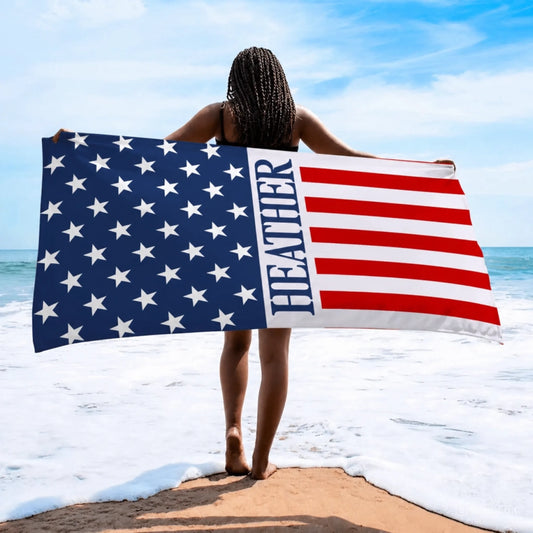 Custom name American flag beach towel with the name Heather displayed on a patriotic banner for Fourth of July vacations.