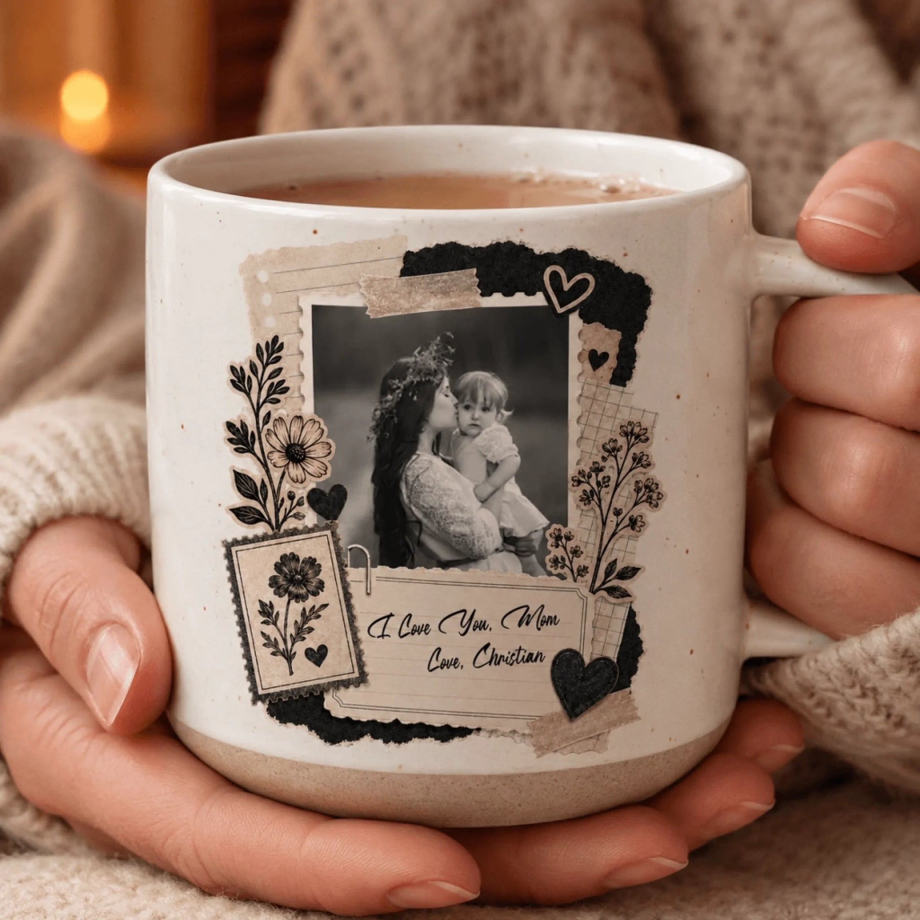 Close-up of hands holding a custom-designed ceramic mug featuring a sentimental mother and baby photo collage.