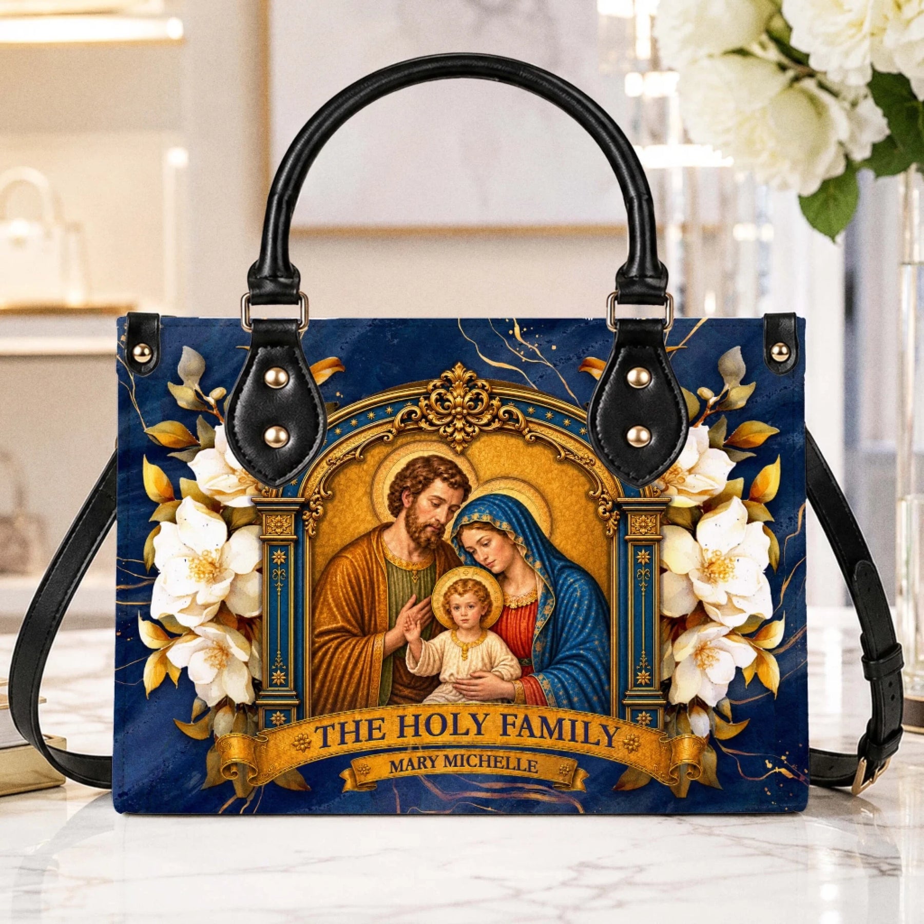 A beautiful blue tote bag featuring The Holy Family artwork and the personalized name Mary Michelle, perfect for religious gifts.