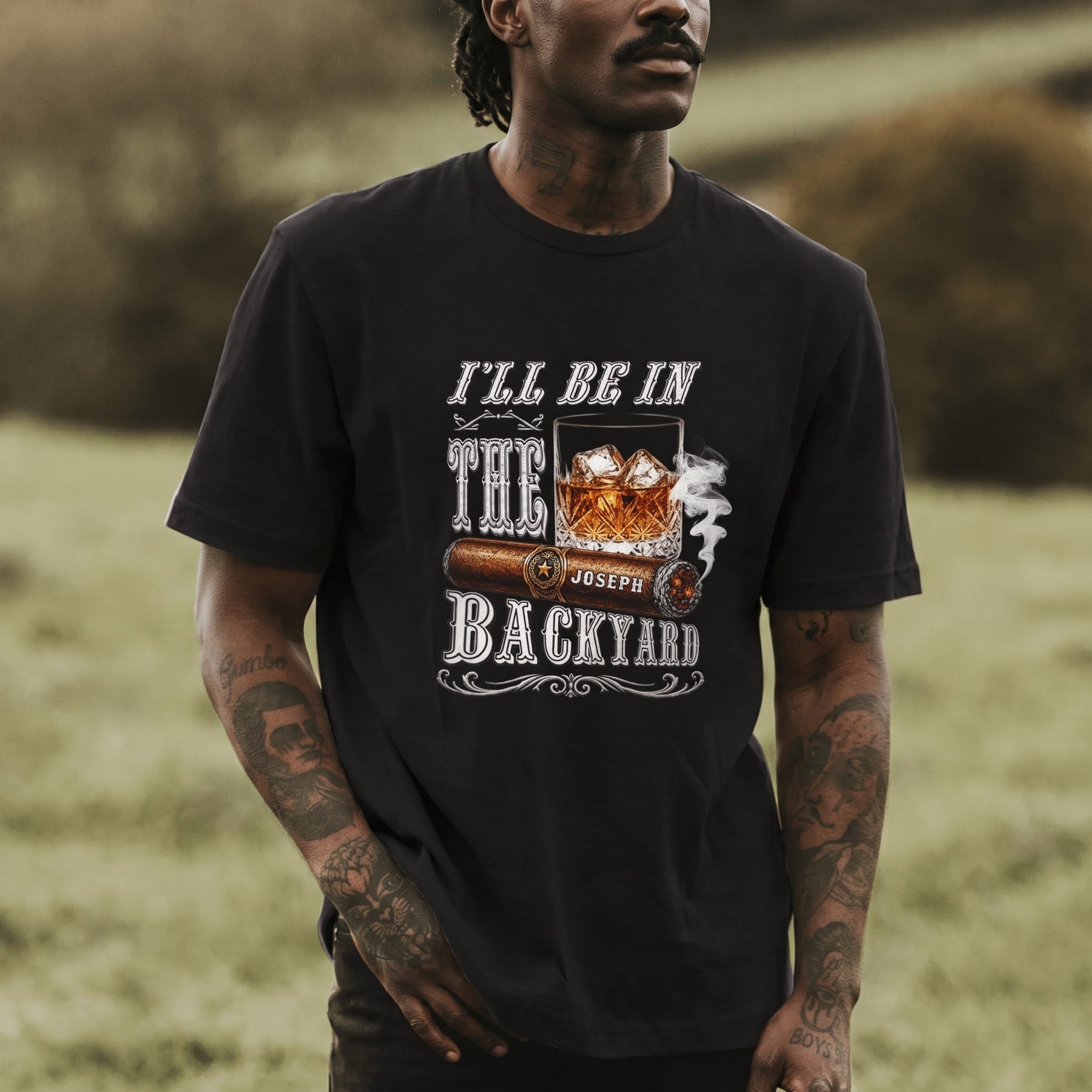 Custom men's t-shirt featuring a cigar and whiskey graphic with the personalized name Joseph, casual backyard style.