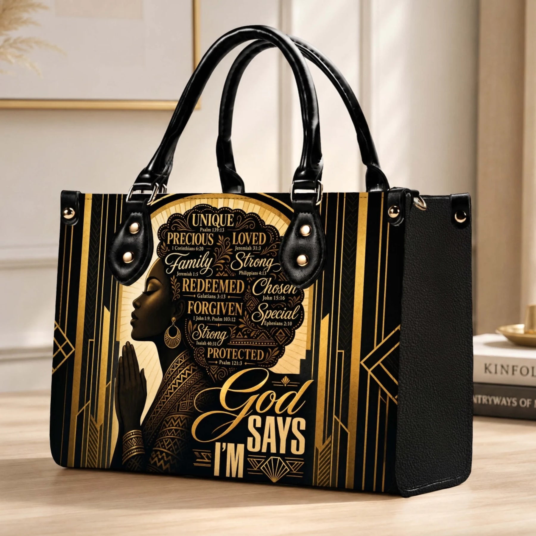 Stylish faith-inspired handbag with a gold and black art deco pattern and a praying woman portrait illustration.