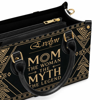 Inside view of a black and gold personalized handbag with a zipped compartment for a custom mom gift accessory.