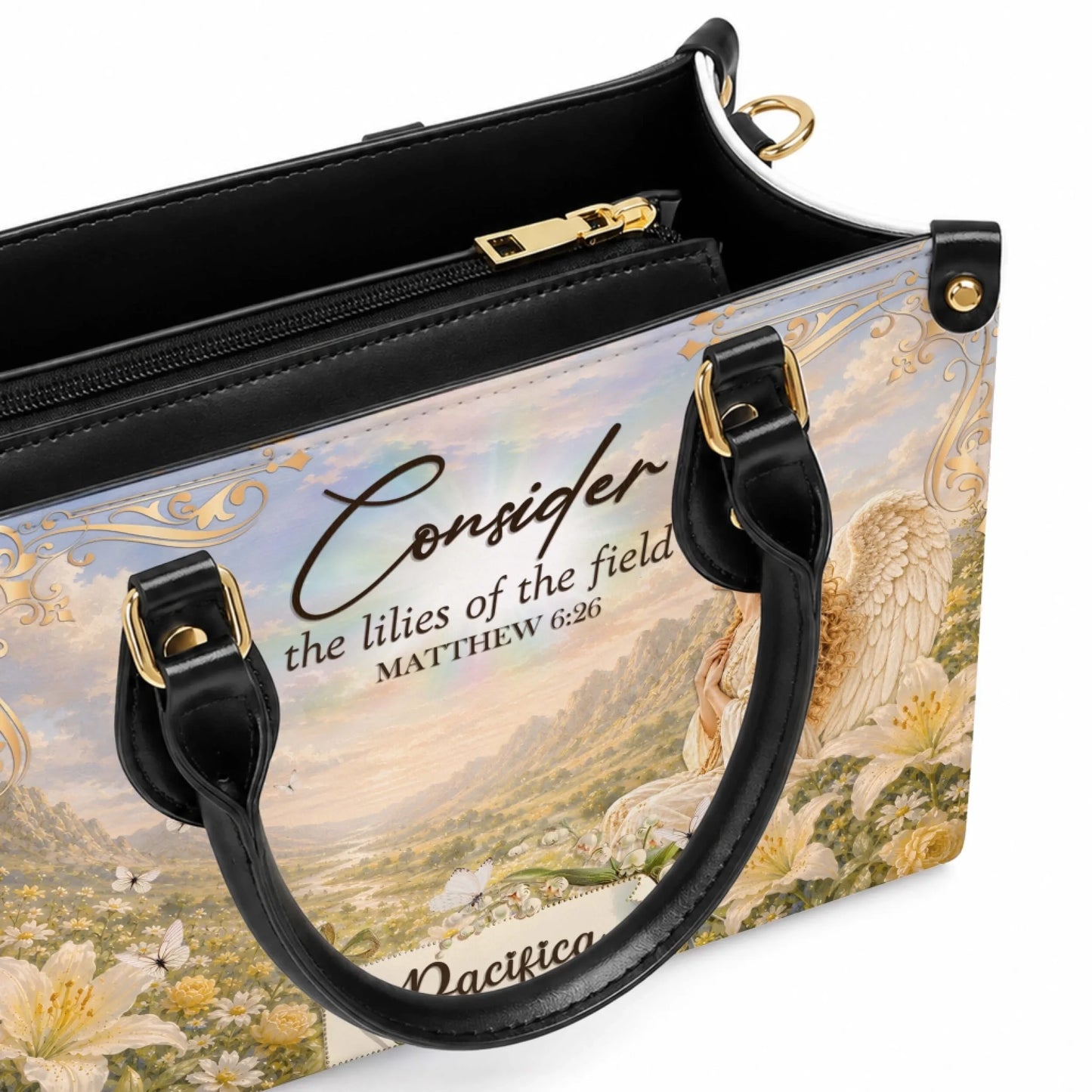 An open view of the interior of a personalized handbag featuring an angel and lilies design with a convenient zipper pocket