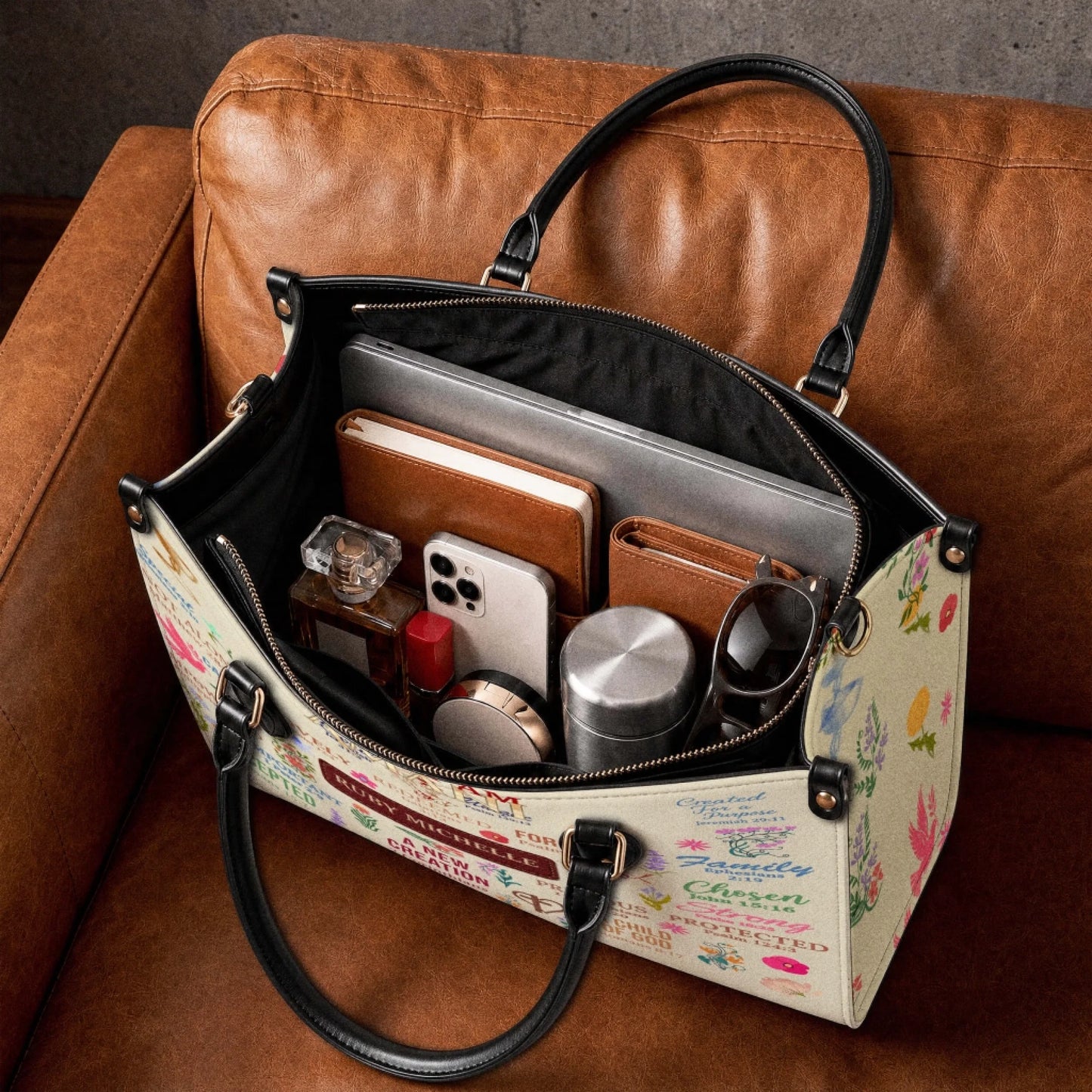 Inside view of a spacious personalized tote bag carrying a laptop, notebook, phone, perfume, and personal accessories.