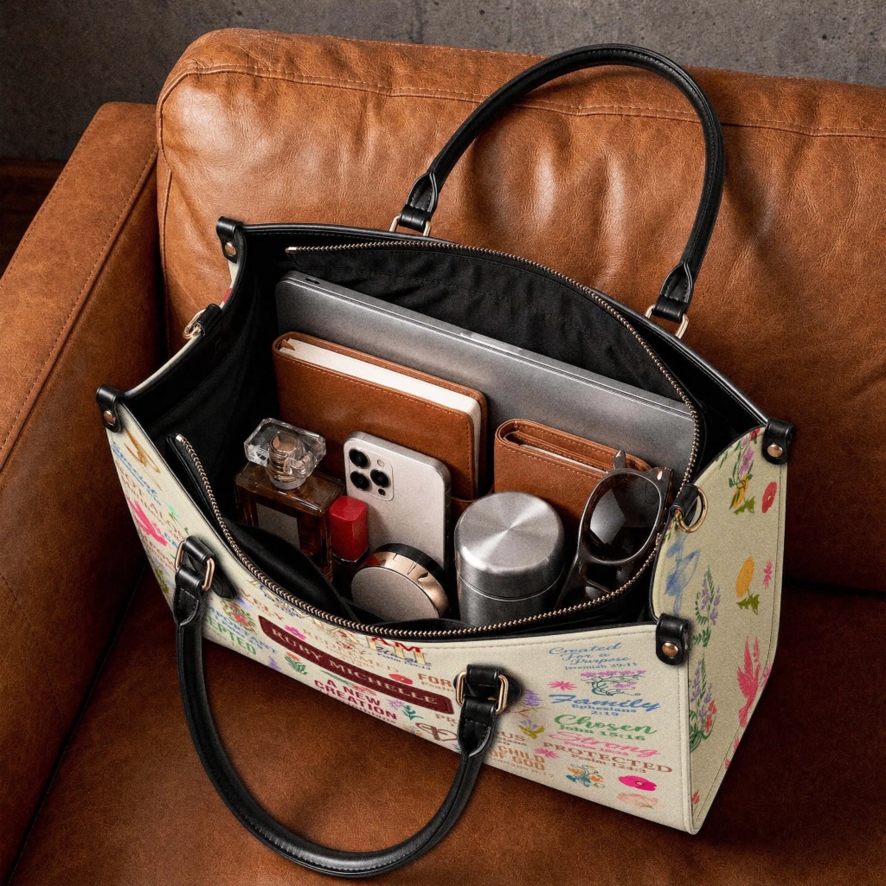 Inside view of a spacious personalized tote bag carrying a laptop, notebook, phone, perfume, and personal accessories.