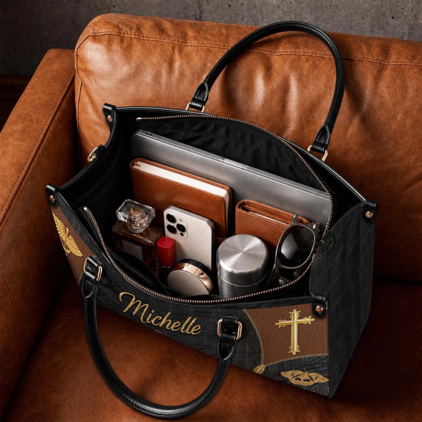 Spacious interior of a personalized nurse tote bag showing a laptop notebook and personal items on a leather sofa.