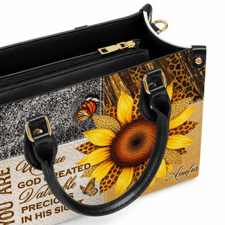 Close up view of the black interior and golden zipper detail on a personalized sunflower design PU leather handbag.