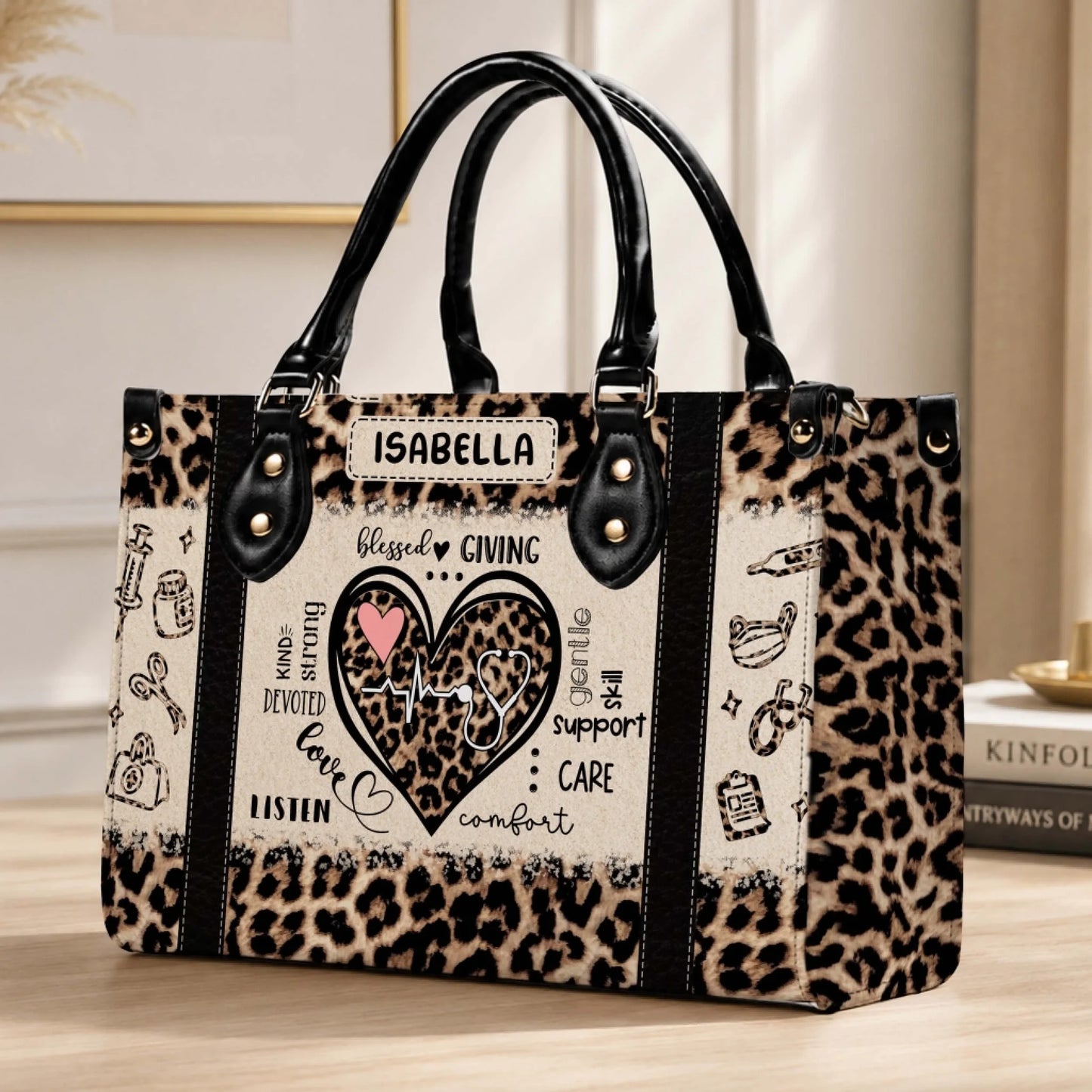 A custom leopard print handbag for nurses featuring a heart design with medical symbols and the name Isabella printed on it.