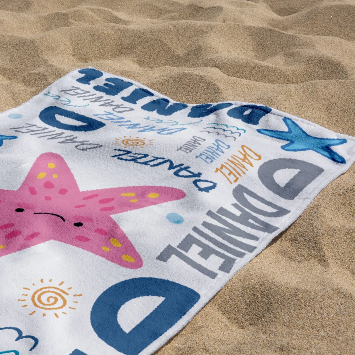 Custom starfish themed beach towel for kids featuring the name Daniel, perfect for summer holidays and beach gear.