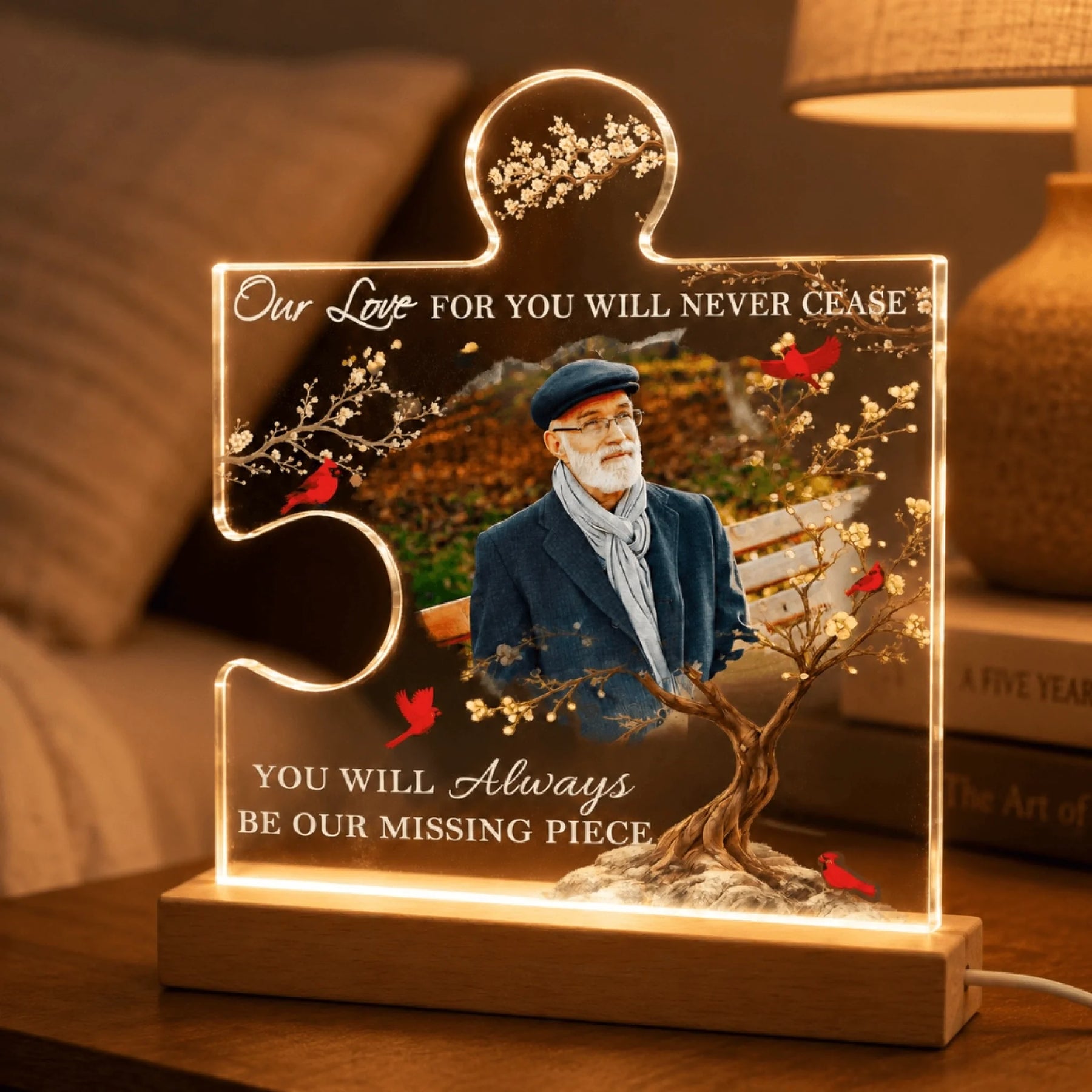Acrylic puzzle piece memorial sign with LED lighting, displaying a portrait of a loved one and cardinal artwork.