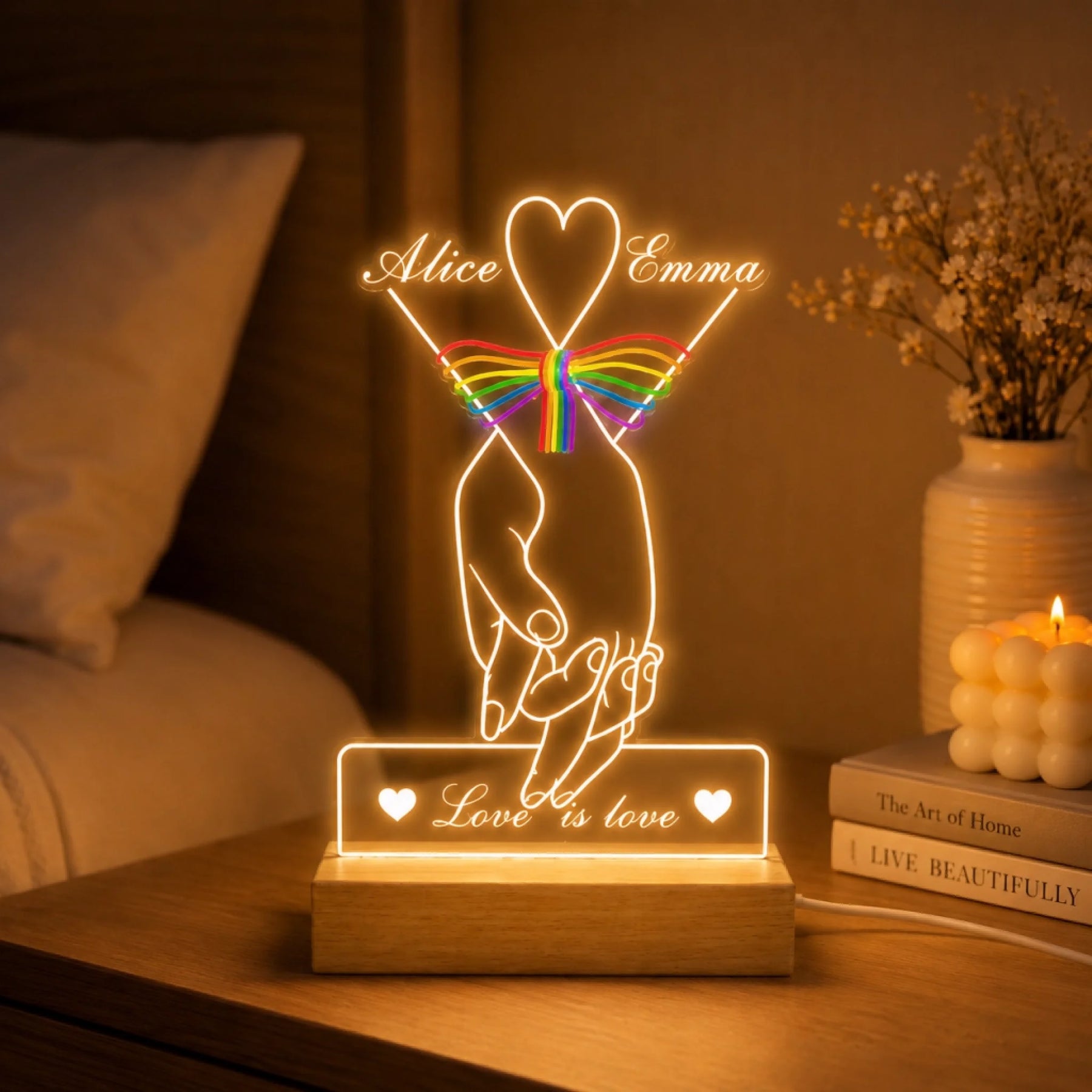Decorative LED night light with hands holding a rainbow bow and 'Love is love' text on a wooden base.