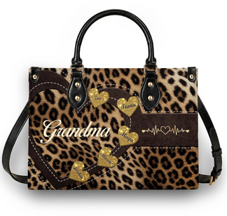 Custom leopard print handbag for grandma with gold heart accents displaying names and a heartbeat symbol design.