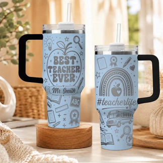 Light blue personalized tumblers with teacherlife hashtag and school supply icons for classroom staff gifts.
