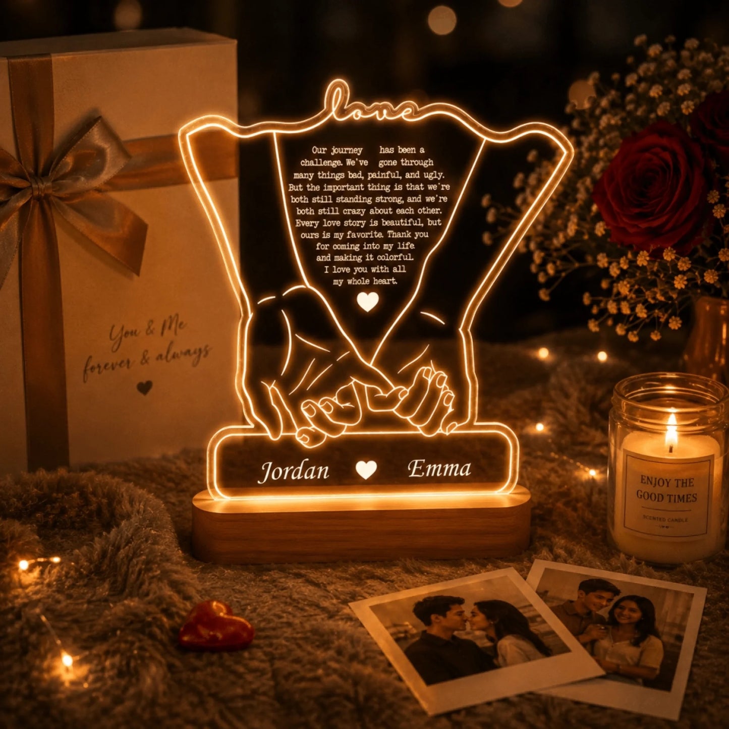 An illuminated lamp depicting clasped hands, a quote, and names "Jordan" and "Emma" in a romantic setting with gifts and photos.