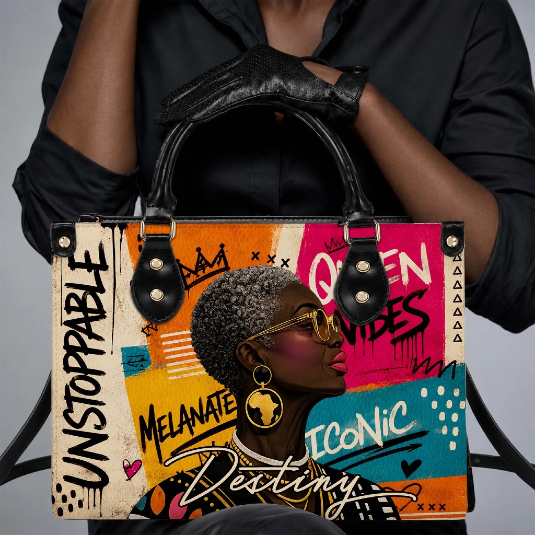 A stylish PU leather handbag featuring a vibrant graphic of a black queen with golden Africa earrings and uplifting text.