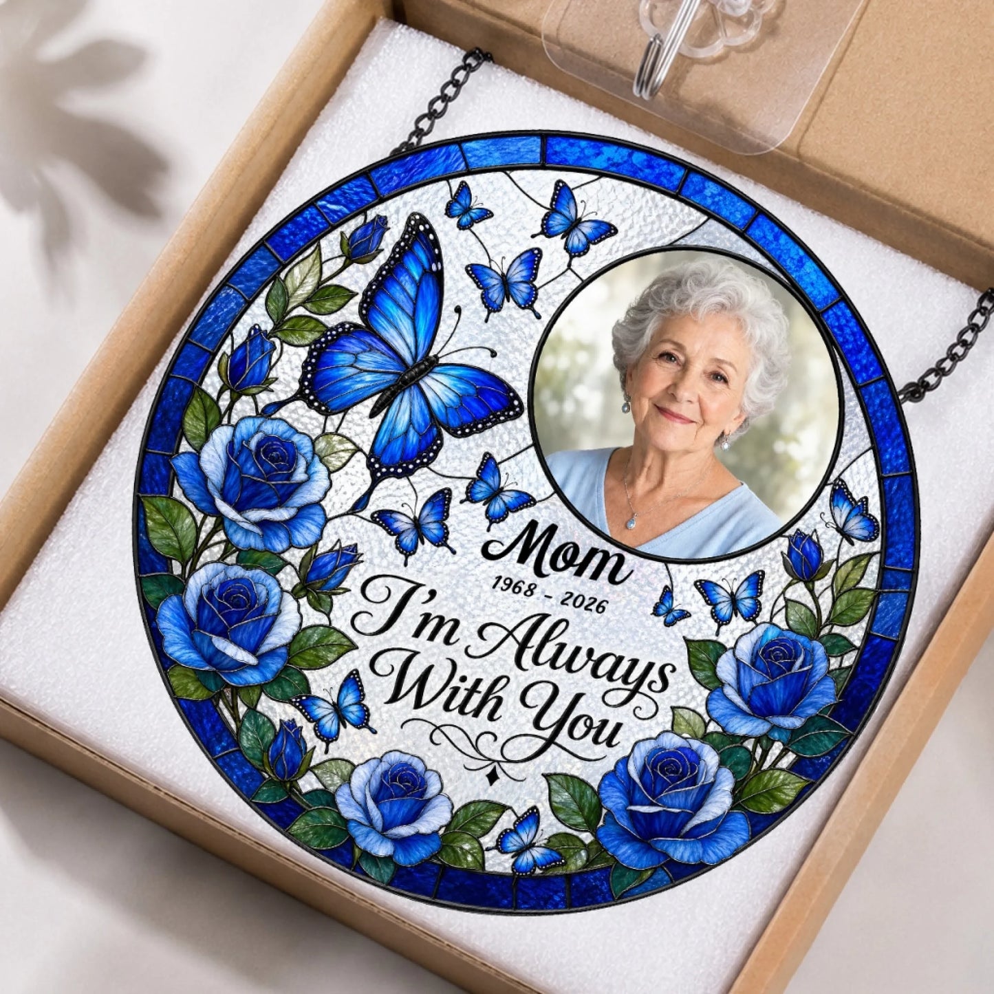 Custom memorial stained glass suncatcher packaged in a gift box, featuring a photo of Mom and blue butterfly art.
