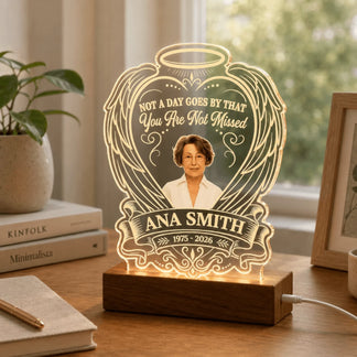 Personalized memorial acrylic LED lamp displayed on a wooden desk, accented with nearby books and plant.