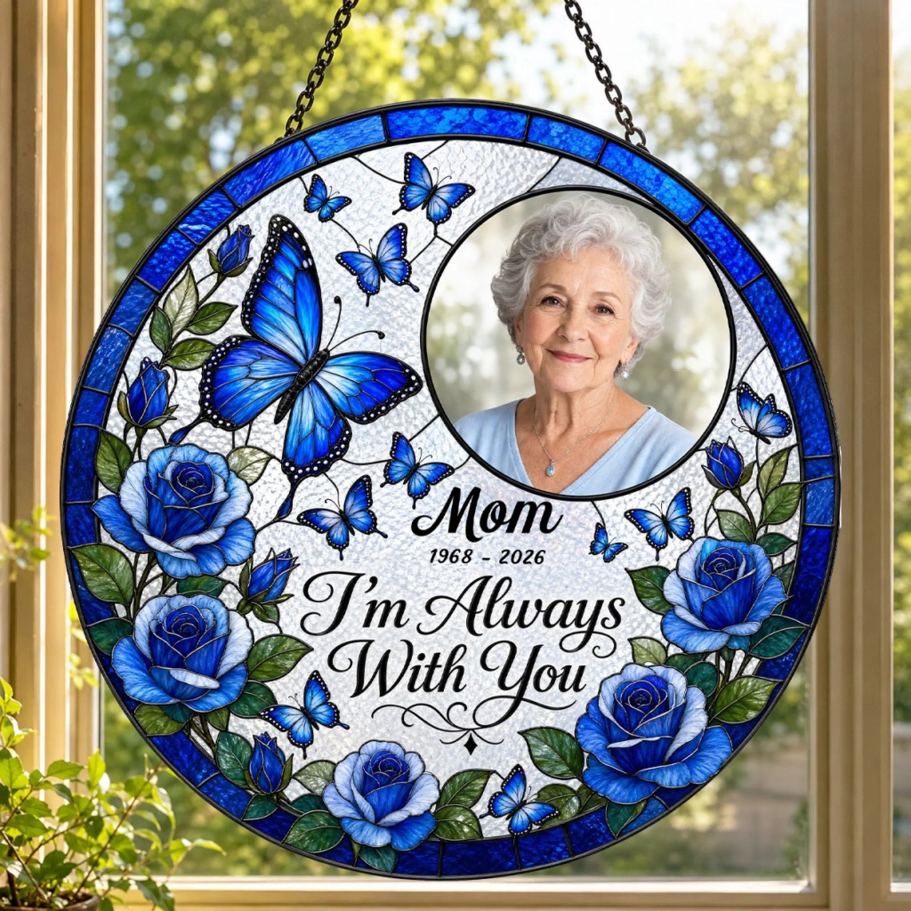 Personalized memorial stained glass suncatcher featuring a custom photo of Mom, blue roses, butterflies, and dates.