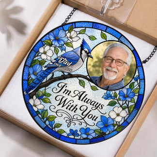 A round stained glass memorial suncatcher with a blue jay and photo in its original protective retail packaging.