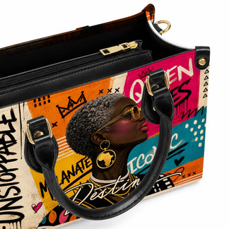 The interior view of a stylish tote bag featuring a vibrant artistic graphic print with gold hardware and zipper.