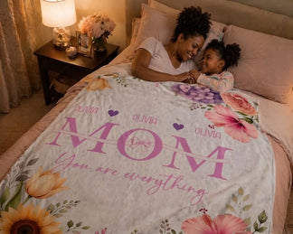 Customized floral Mom You are everything blanket with the name Olivia, displayed on a bed as a thoughtful Mother's Day gift.