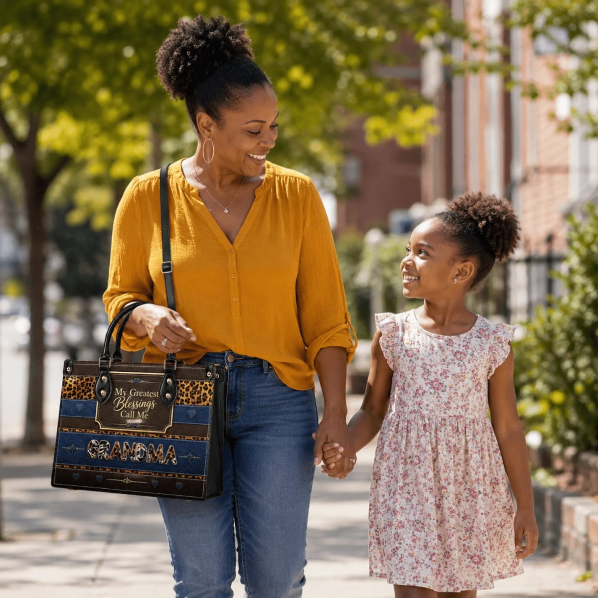 A mother and daughter walking outdoors with the woman carrying a personalized leopard print Grandma tote bag.