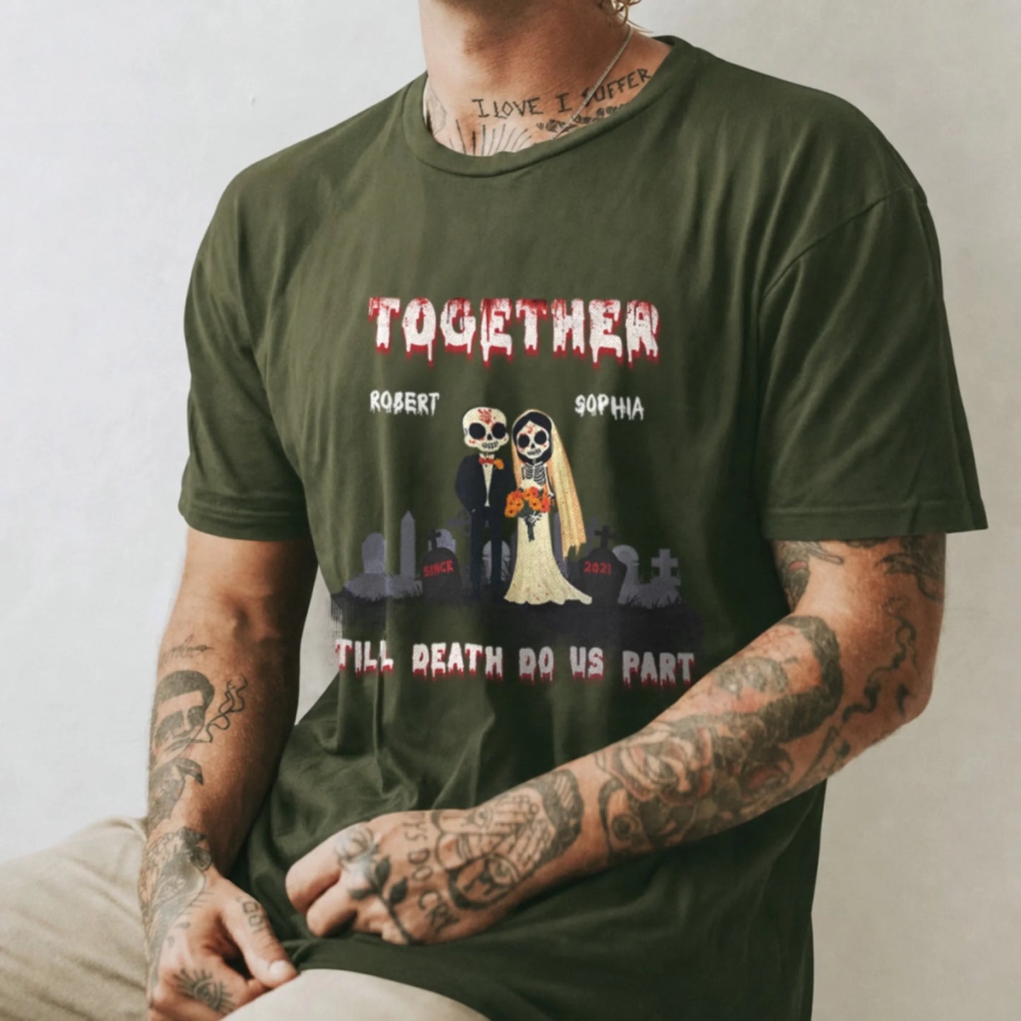 An olive green personalized t shirt with a skeleton bride and groom graphic, custom names Robert and Sophia, and a romantic dark wedding theme.
