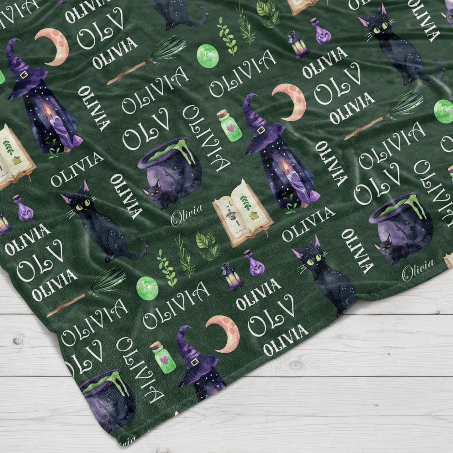 Personalized green Halloween fleece blanket featuring cute cats, magic spells, and custom name for holiday gifting.